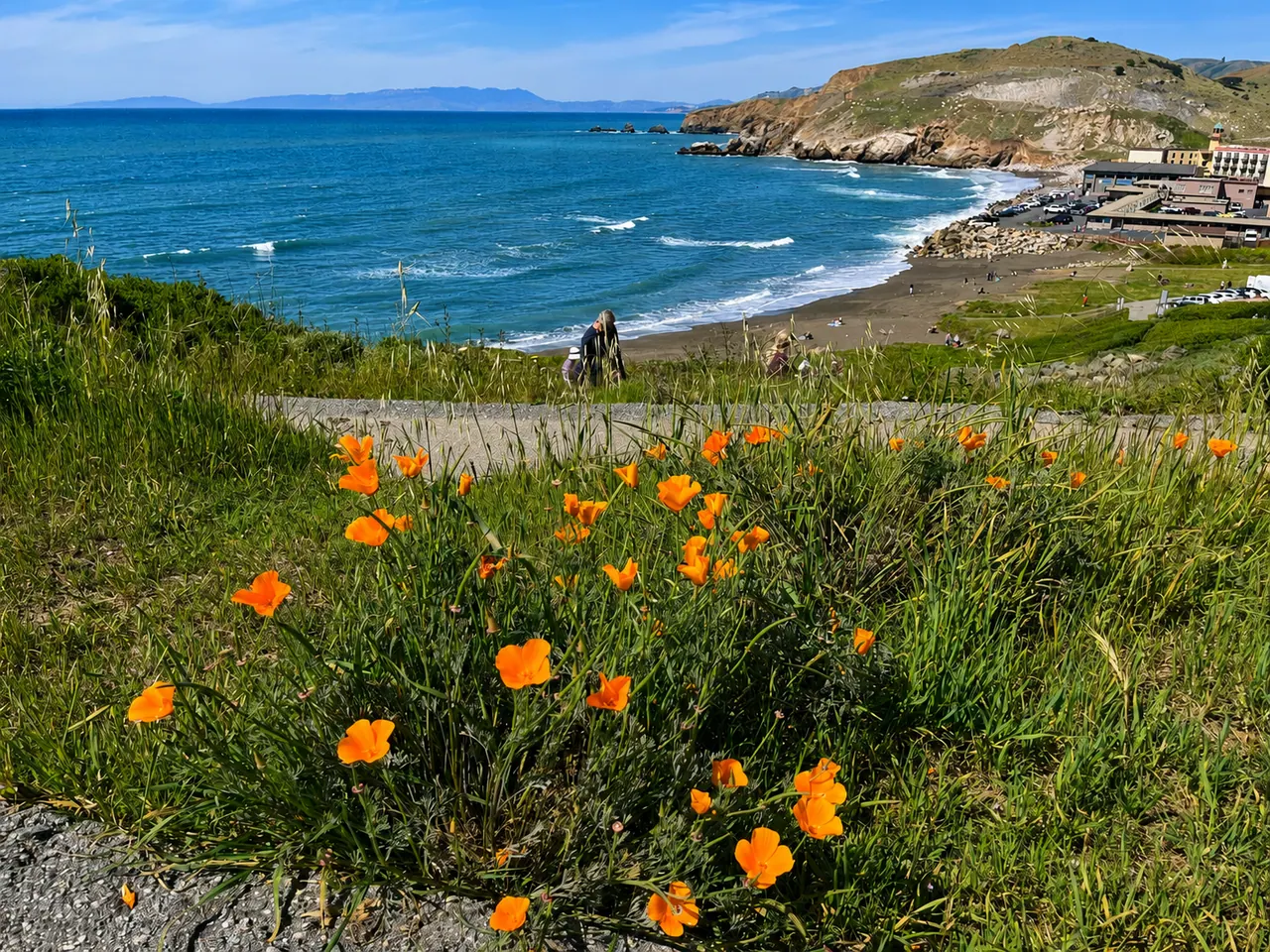 Coastal bluffs, a small cove, and hillside homes along the Pacifica coast