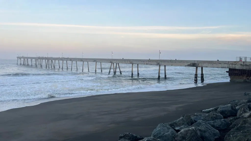 Pacifica Pier at sunset with soft coastal light and ocean waves along the San Mateo County coast in California